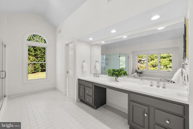 bathroom featuring tile patterned flooring, vanity, independent shower and bath, and lofted ceiling