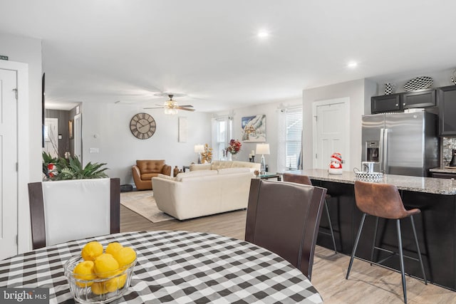 dining room with light hardwood / wood-style flooring and ceiling fan