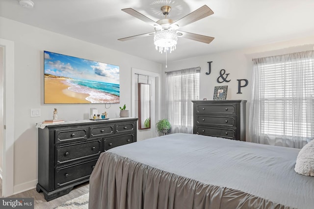 bedroom with ceiling fan and light hardwood / wood-style floors