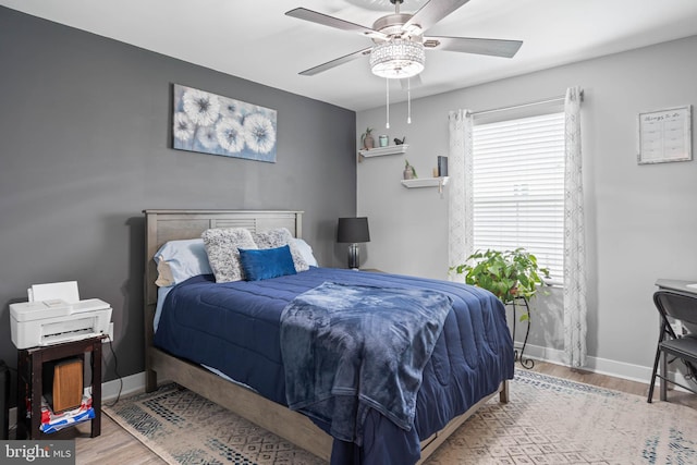 bedroom with hardwood / wood-style flooring and ceiling fan