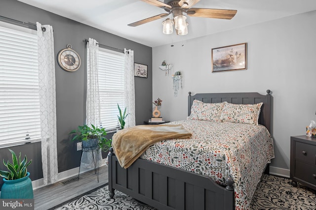 bedroom with ceiling fan and light wood-type flooring