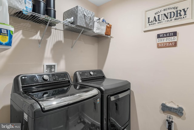 clothes washing area featuring separate washer and dryer