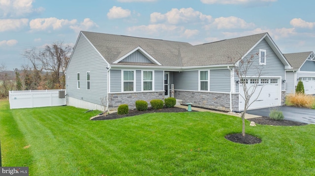 view of front of property featuring a front lawn and a garage