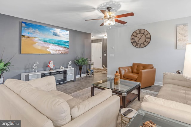 living room with hardwood / wood-style flooring and ceiling fan