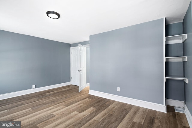 unfurnished room featuring wood-type flooring