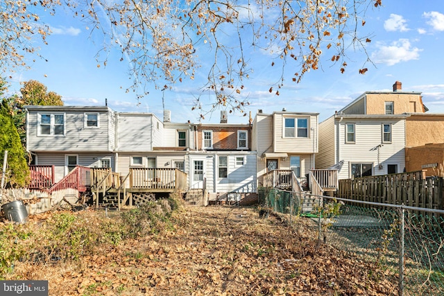 rear view of house with a wooden deck