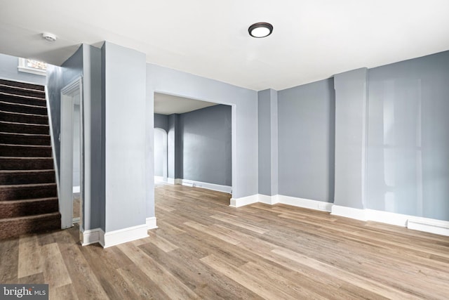 basement with light hardwood / wood-style flooring