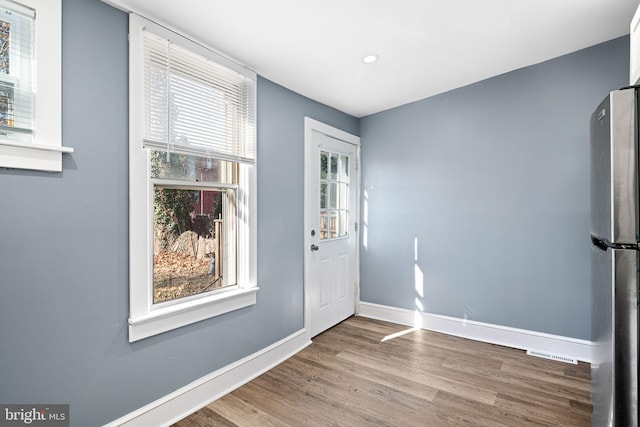 foyer with plenty of natural light and hardwood / wood-style floors