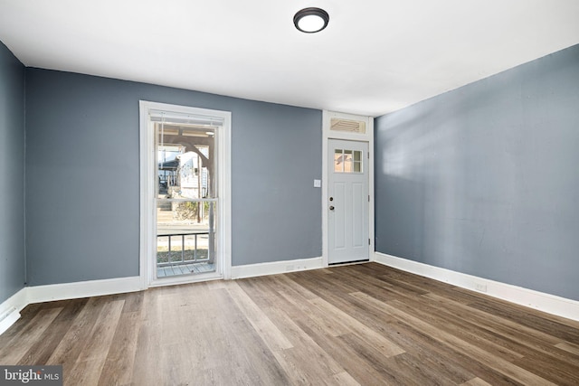 empty room with hardwood / wood-style flooring