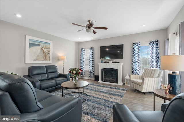 living room with light hardwood / wood-style flooring and ceiling fan