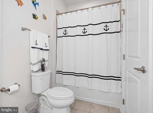 bathroom featuring toilet, shower / tub combo, and tile patterned floors