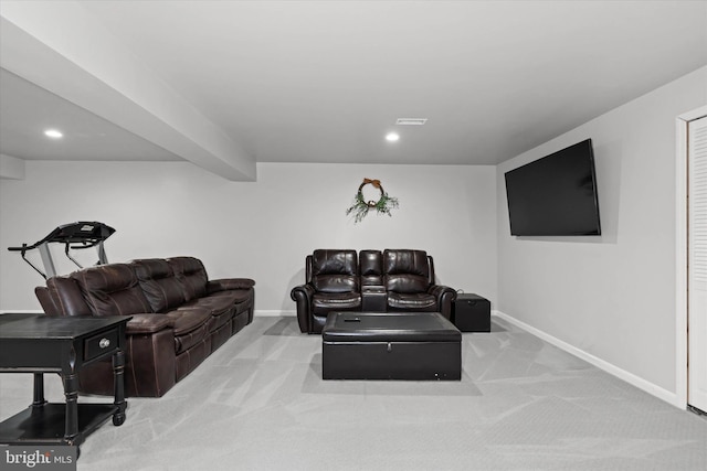 carpeted living room with beam ceiling