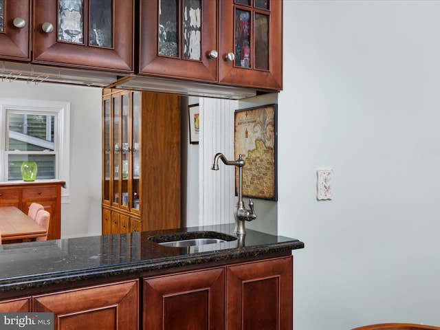 bar with dark stone counters and sink