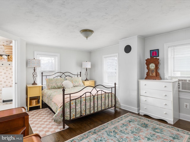 bedroom featuring dark hardwood / wood-style flooring and a textured ceiling