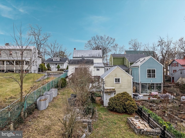 rear view of property with a lawn