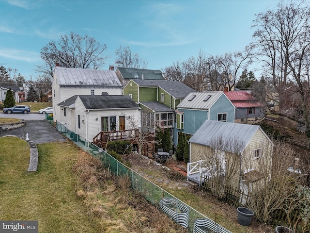 rear view of property with a wooden deck and a yard