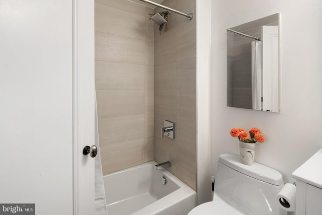 full bathroom featuring toilet, vanity, and tiled shower / bath