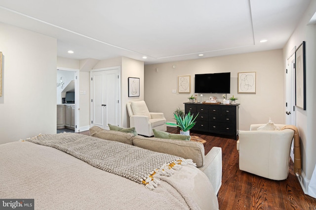 bedroom with dark hardwood / wood-style floors