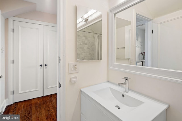 bathroom with vanity, curtained shower, and wood-type flooring