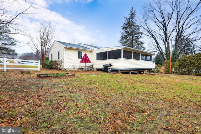 view of front of house featuring a front yard and a sunroom