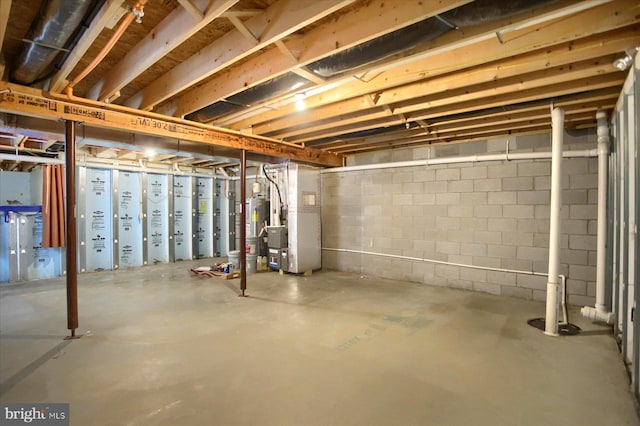 basement with water heater and heating unit