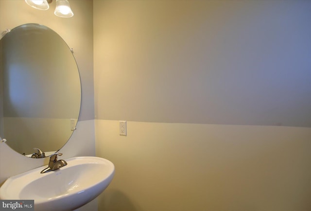 bathroom featuring vaulted ceiling and sink