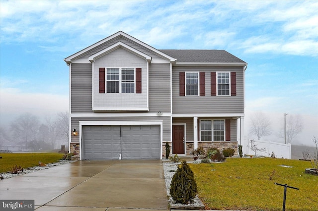 view of front of property featuring a garage and a front lawn