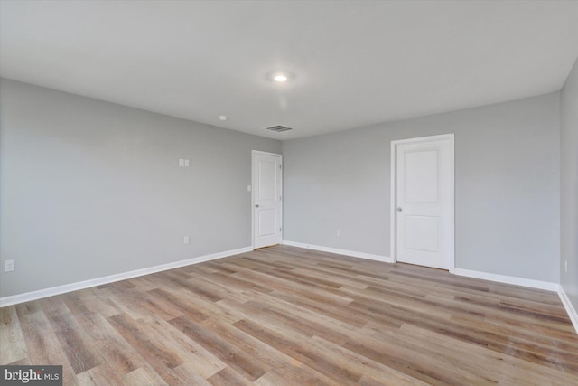 spare room featuring light hardwood / wood-style floors