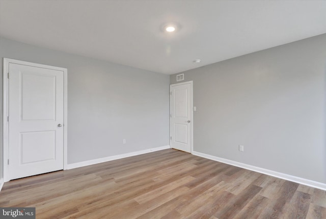 spare room featuring light hardwood / wood-style flooring