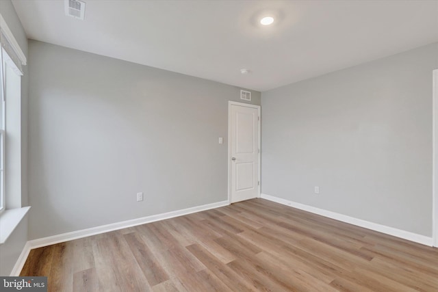 spare room featuring light hardwood / wood-style flooring