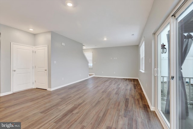 unfurnished room with a healthy amount of sunlight and wood-type flooring