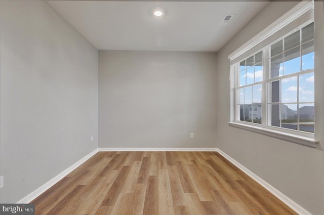 empty room with light hardwood / wood-style flooring