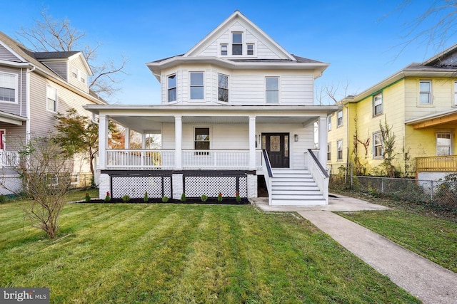 view of front of property featuring covered porch and a front lawn