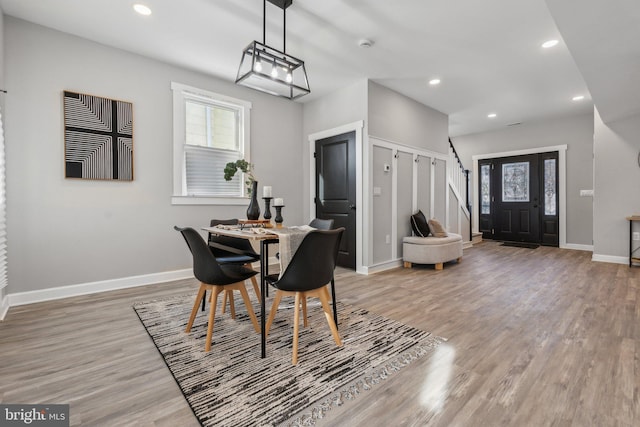 dining space with wood-type flooring