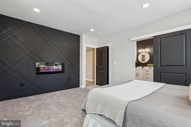 carpeted bedroom with ensuite bathroom