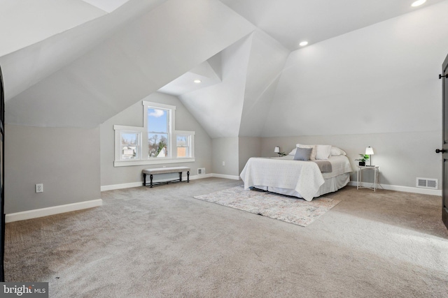 unfurnished bedroom with carpet and lofted ceiling