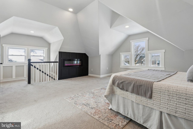 bedroom featuring carpet floors, multiple windows, and lofted ceiling