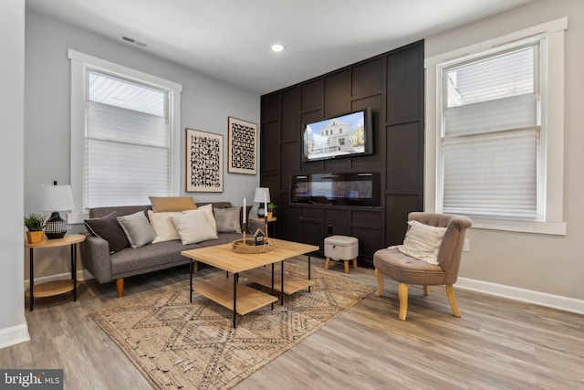 living room featuring light hardwood / wood-style flooring and plenty of natural light