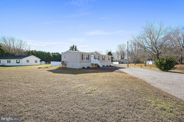 view of property exterior featuring a lawn