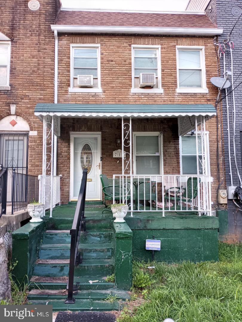 view of property with a porch and cooling unit