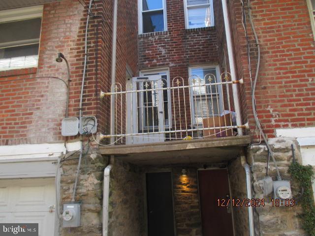 view of side of home featuring a balcony