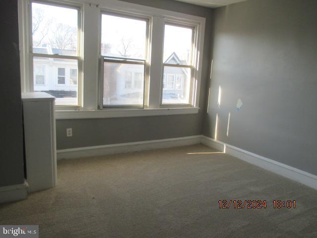 carpeted spare room with a healthy amount of sunlight