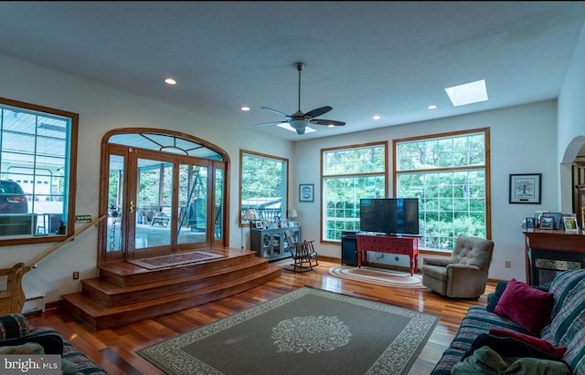 living room with hardwood / wood-style floors, plenty of natural light, and ceiling fan