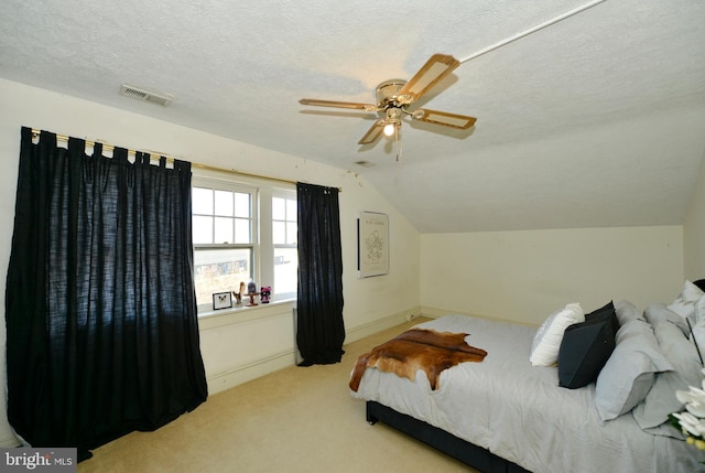 carpeted bedroom with a textured ceiling, ceiling fan, and lofted ceiling