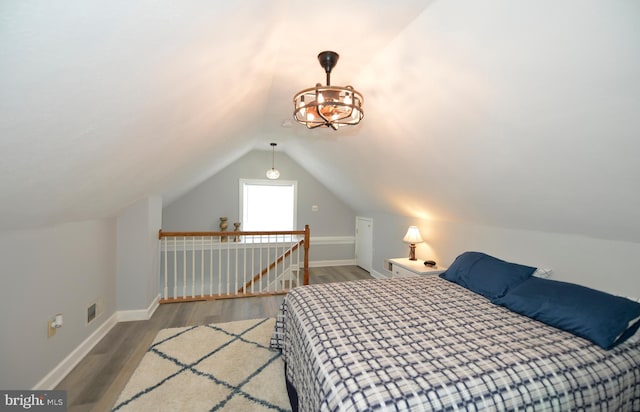 bedroom featuring lofted ceiling and hardwood / wood-style flooring