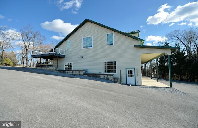 back of house with a carport