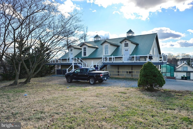 rear view of house featuring a deck