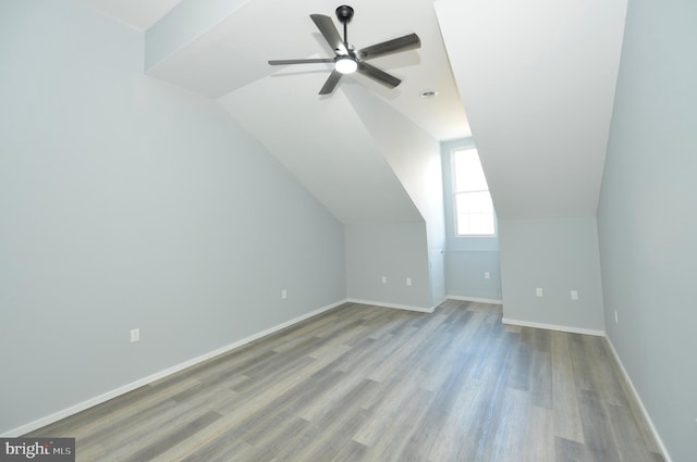 additional living space with ceiling fan, vaulted ceiling, and light wood-type flooring