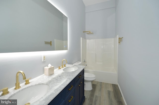 full bathroom featuring toilet, hardwood / wood-style floors, vanity, and bathing tub / shower combination