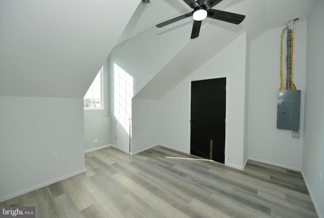 bonus room featuring ceiling fan, light hardwood / wood-style floors, electric panel, and vaulted ceiling